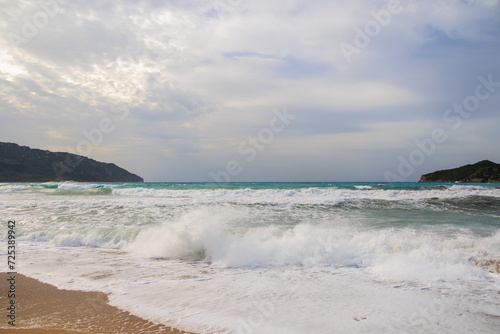 The sandy beach of Agios Georgios on the island of Corfu on a stormy day with high waves