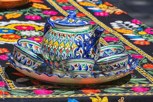 Tea set. Teapot and cups. Traditional ceramics, typical handicraft souvenir in Bukhara (Buxoro) street market. Uzbekistan
