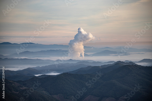 Beautiful morning scenery with fog in the background at Mae Moh Lignite Coal Power Plant, Lampang, Thailand Industrial white vapor from cooling and tower pipes, industrial and environmental themes