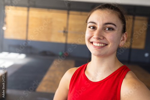 Closeup portrait of caucasian beautiful young woman smiling and looking at camera in health club photo