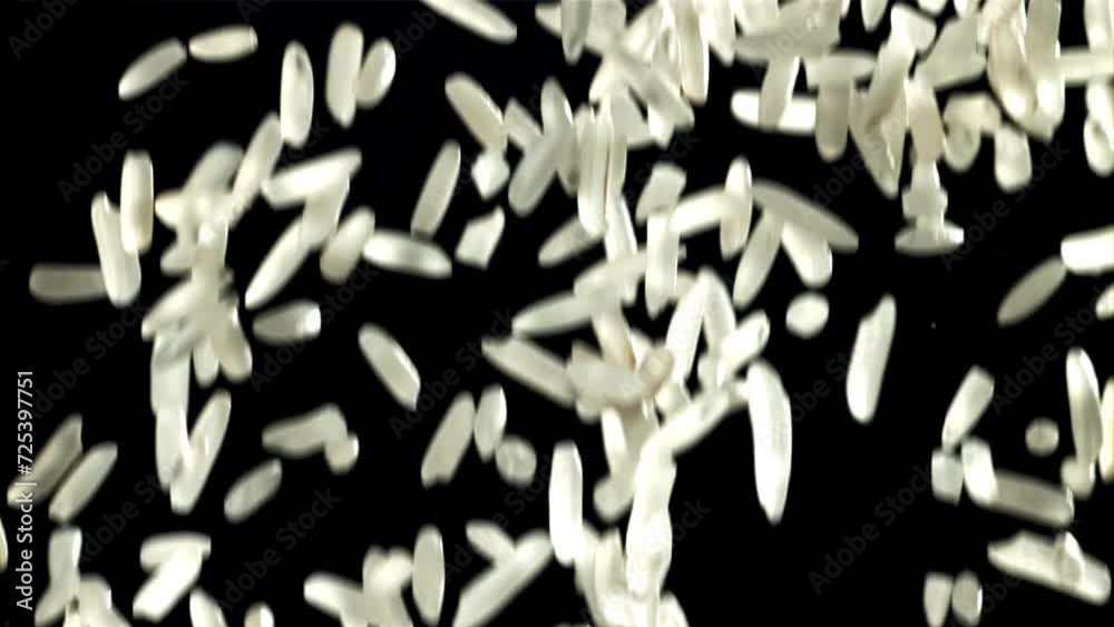 Grains of rice falling on black background. Filmed on a high-speed camera at 1000 fps. High quality FullHD footage
