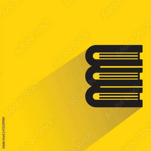 pile of books icon with shadow on yellow background