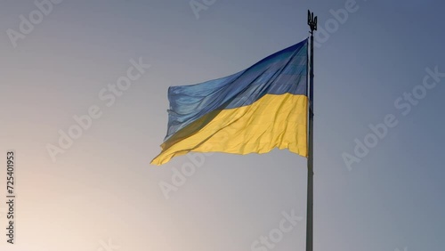 State flag of Ukraine. Slow motion of a large Ukrainian flag fluttering in the sky. Blue and yellow national symbol of Ukraine. Large flag on a flagpole.