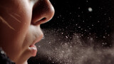 Close-up of woman sneezing, concept of flu, allergies, and health issues.
