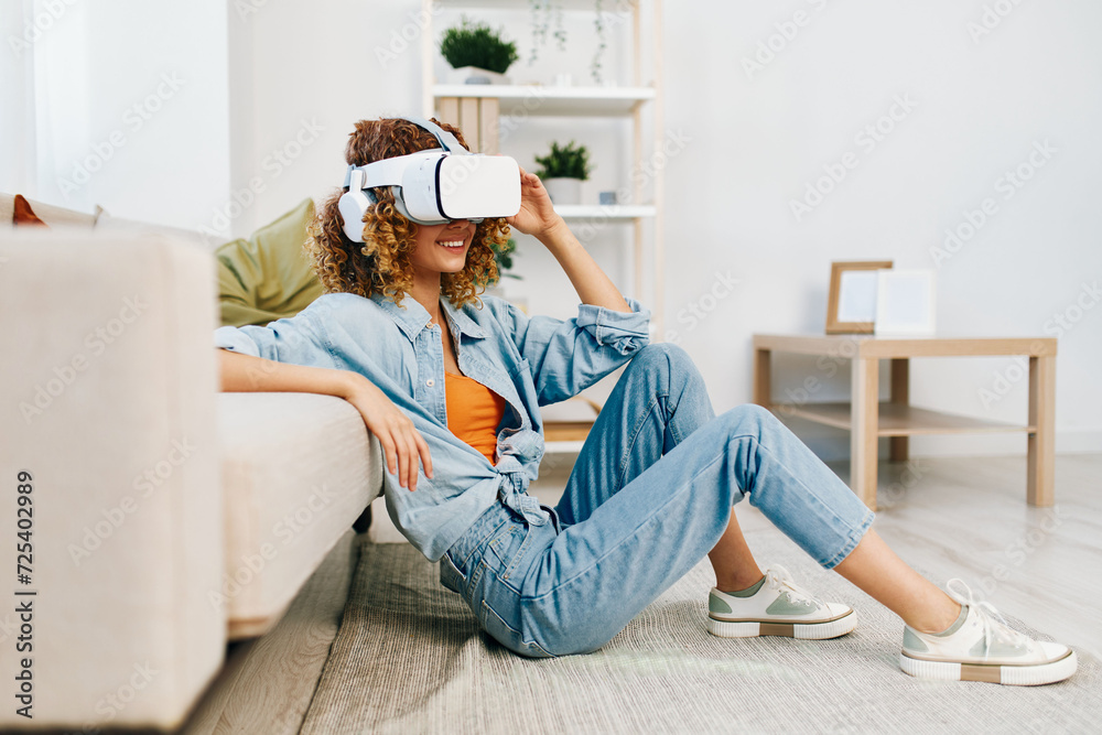 Virtual Reality Enjoyment: A Young Woman Smiling and Laughing, Using VR Goggles at Home, Surrounded by Modern Technology in a Futuristic Living Room. Virtual Reality Enjoyment: A Young Woman Smiling and Laughing, Using VR Goggles at Home, Surrounded by Modern Technology in a Futuristic Living Room.