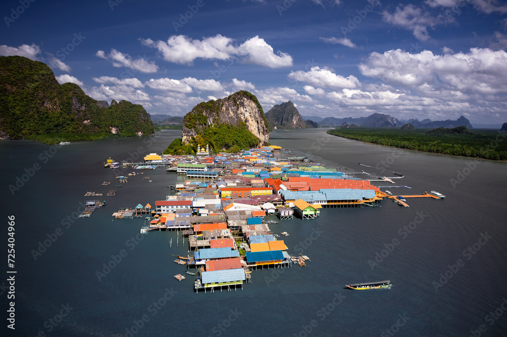 Mesmerizing aerial shot of Koh Panyee, Thailand's floating village. Vibrant stilted structures rise above the turquoise waters, capturing the essence of a unique and captivating way of life