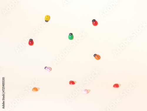 Pattern of multi colored ladybugs on white background. Minimal, spring concept.