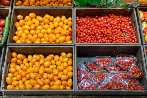 Tomatoes in wooden boxes in the fruit and vegetable section of a grocery supermarket. Sale of tomatoes. Vegetables in a grocery store. © 8th