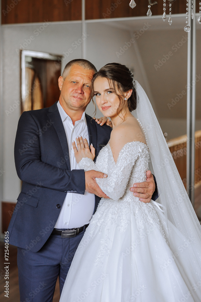 A beautiful bride with her father on her wedding day. The best moments of the wedding day. Daughter and father.