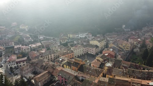 4K footage of a  small town in the center of Italy during a foggy day photo