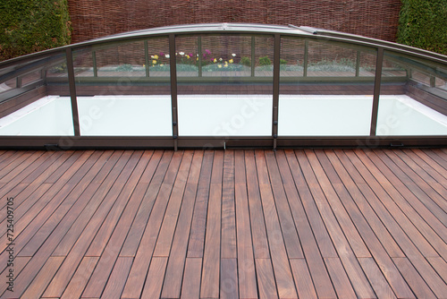 Photos Swimming pool enclosure with wood deck and private fence on background