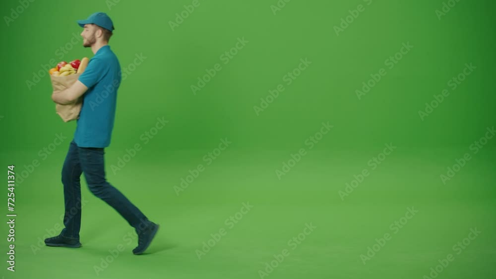 Green Screen Delivery Man Brings Paper Bag with Food. Courier on the Way to Deliver Order to a Client. Deliveryman Worker Deliver Online Order Client. Green Screen Delivery Man Brings Paper Bag with Food. Courier on the Way to Deliver Order to a Client. Deliveryman Worker Deliver Online Order Client.
