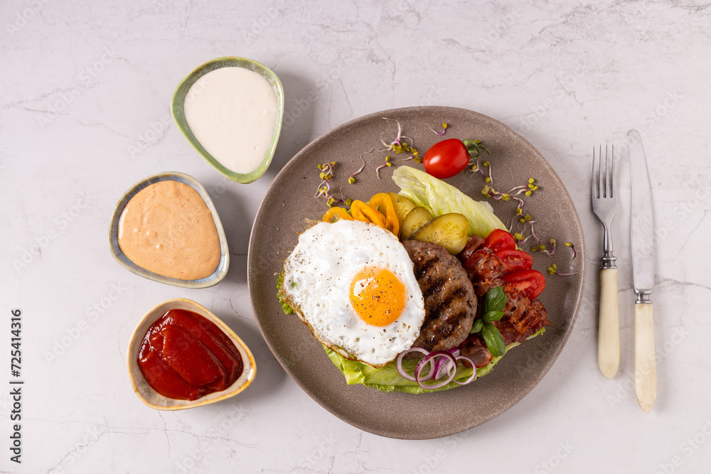 Beef burger without a bun with a fried egg Beef burger without a bun with a fried egg
