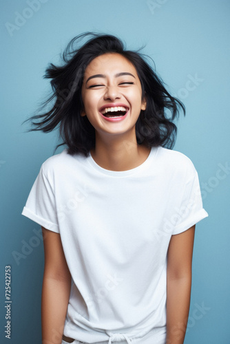 Young happy smiling Asian woman model wearing tshirt looking at camera on color background. Face skin hair care korean cosmetic and makeup, fashion ads. Beauty portrait. White t-shirt mock up template