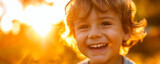 Close up portrait of little boy smiling in backlight. AI generated.