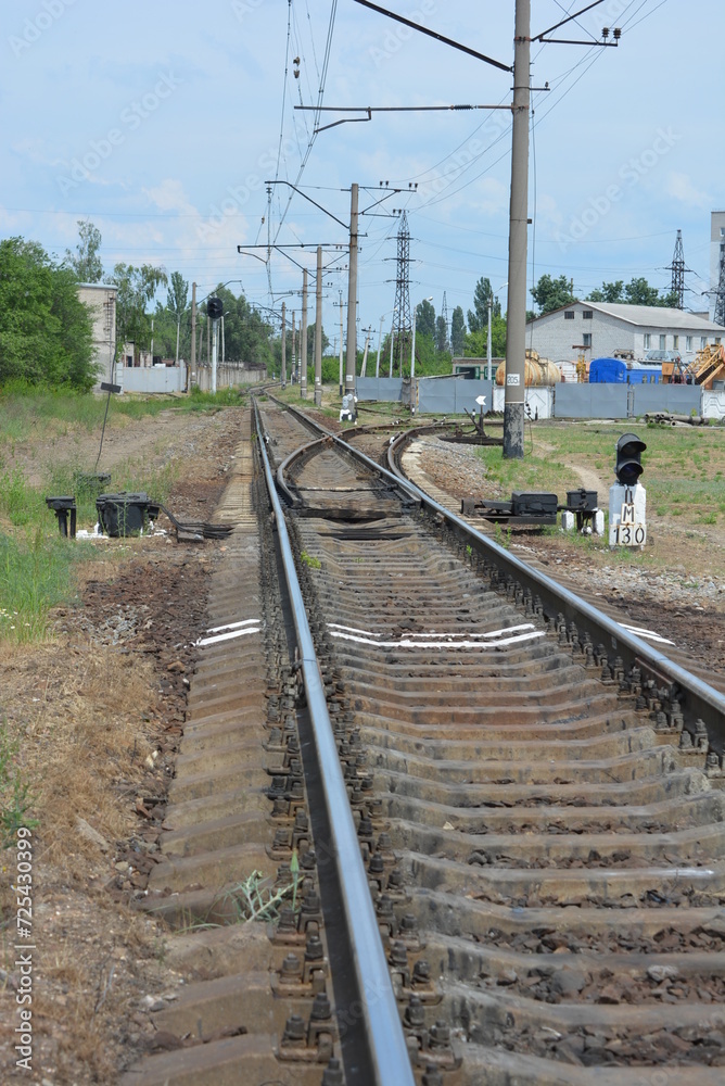Railway tracks, electric lines, metal rails on which electric trains run, trains by Ukrainian railway.