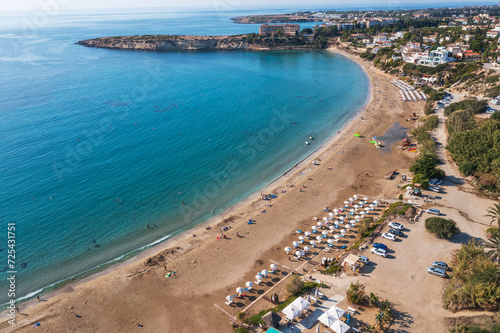 Fototapeta Naklejka Na Ścianę i Meble -  Expansive aerial view of Cyprus sandy beach and azure ocean water, natural beauty of coastline and vastness of sea. Summer travel and mediterranean resorts.