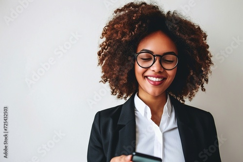 a woman smiling while holding a phone