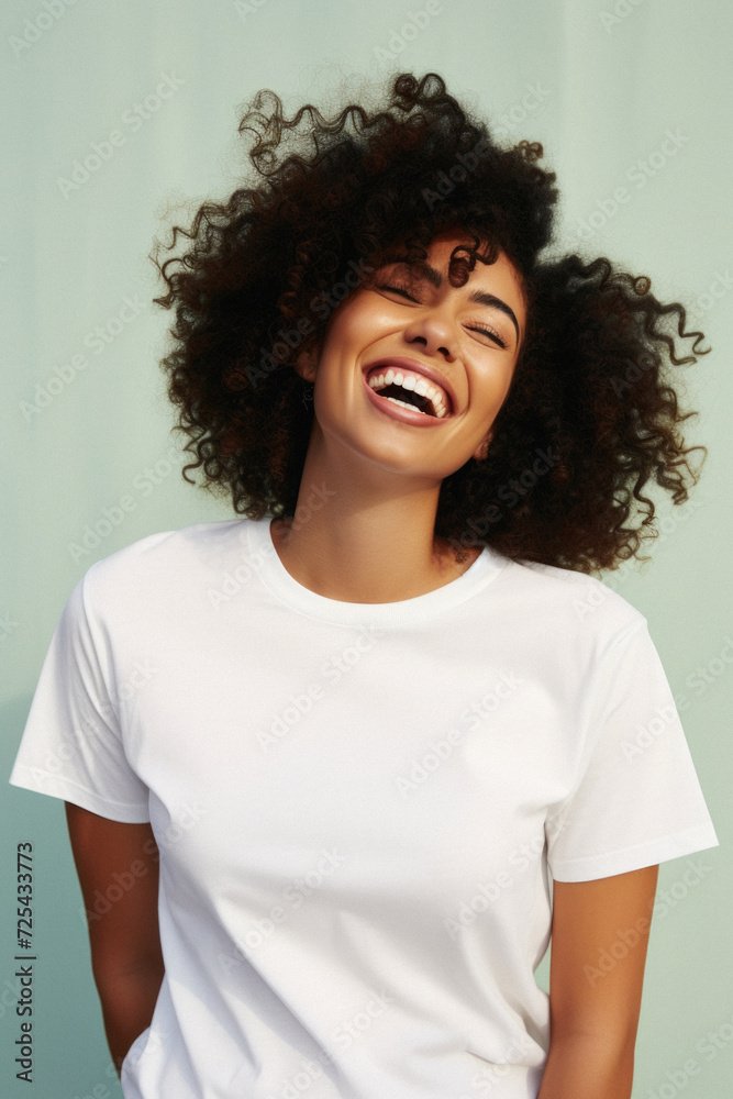 Young happy smiling African American woman model wearing tshirt standing on color background. Face skin hair care cosmetics makeup, fashion ads. Beauty portrait. White t-shirt mock up template . Young happy smiling African American woman model wearing tshirt standing on color background. Face skin hair care cosmetics makeup, fashion ads. Beauty portrait. White t-shirt mock up template .