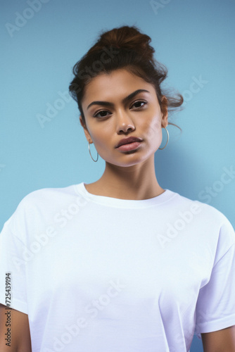 Young cool Latin woman hipster gen z model wearing mockup tshirt looking at camera on color background. Face skin care cosmetics makeup, fashion ads. Beauty portrait. White t-shirt mock up template .