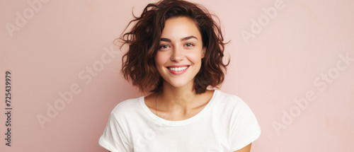Young happy woman, smiling gen z girl model wearing tshirt looking at camera standing on color background. Face skin care cosmetics makeup, fashion ads. Beauty portrait. White t-shirt mock up template