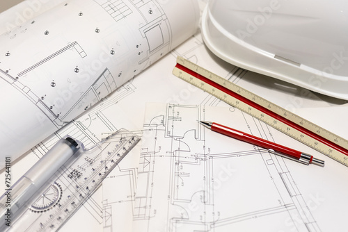 Background of architecture plans, hard hat and architect tools on table
