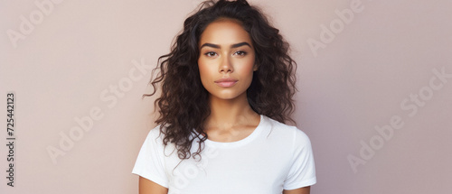 Young cool Latin woman hipster gen z model wearing mockup tshirt looking at camera on color background. Face skin care cosmetics makeup, fashion ads. Beauty portrait. White t-shirt mock up template . photo