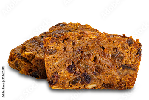 Closeup view of sliced delicious homemade fruitcake isolated on white background with clipping path. © takepicsforfun