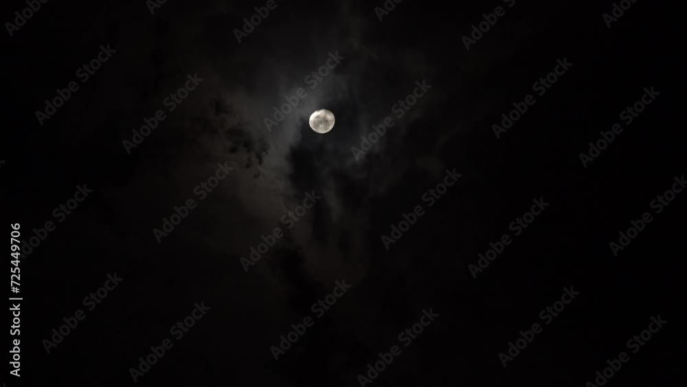 Black clouds and moon. The magic of the night sky. Time lapse mesmerizing beauty of moon Black clouds and moon. The magic of the night sky. Time lapse mesmerizing beauty of moon