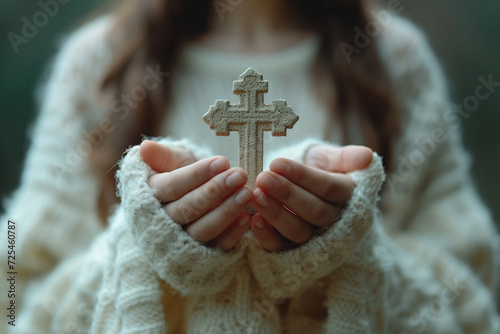 A bright Catholic cross in women's hands.
