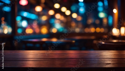 empty wooden tabletop against the backdrop of a cozy evening cafe, restaurant with colorful lights. background. photo for background 