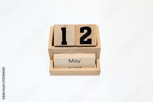 12h of May wooden perpetual calendar. Shot close up isolated on a white background