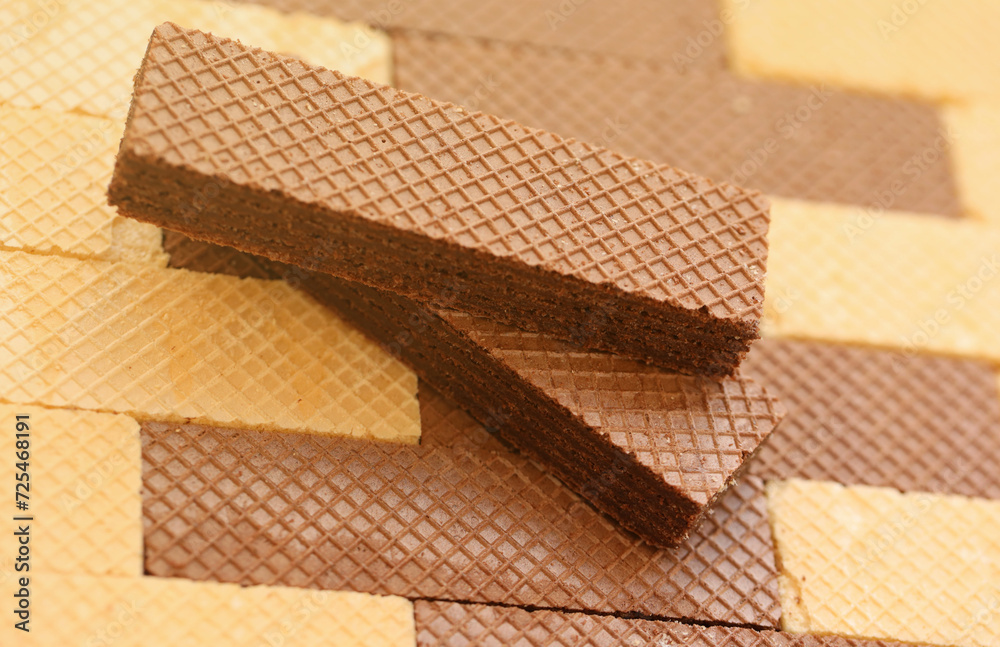 Stacked delicious chocolate wafers in large amount. Two different flavours of classic small waffles Stacked delicious chocolate wafers in large amount. Two different flavours of classic small waffles