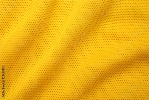 Yellow soccer jersey fabric texture, sports wear background, close up