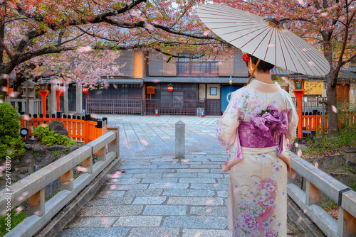 Young Japanese woman in traditional Kimono dress at Tatsumi bashi bridge over Shirakawa river in Gion district, Kyoto