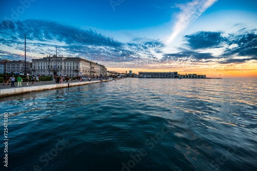 Dusk and night in Trieste. Between historic buildings and the sea.