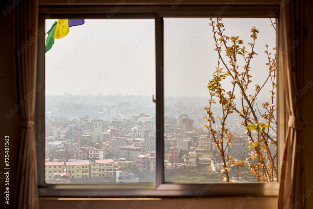 Fototapeta premium View of Kathmandu from hotel window through urban haze with lot of low rise buildings, cityscape creating an ethereal atmosphere in mountain air, Kathmandu air pollution