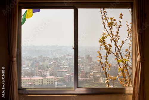 View of Kathmandu from hotel window through urban haze with lot of low rise buildings  cityscape creating an ethereal atmosphere in mountain air  Kathmandu air pollution