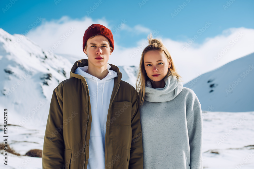 Young woman and man on a snowy mountain