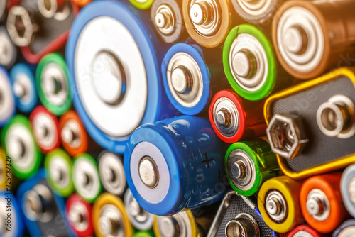 Energy abstract background of colorful batteries.Old used batteries ready for recycling.Used batteries from different manufacturers  waste  collection and recycling Alkaline battery aa size.