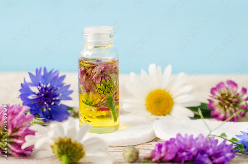 Small bottle with cosmetic oil. Aromatherapy, homemade beauty treatment and herbal medicine ingredients. Small bottle with cosmetic oil. Aromatherapy, homemade beauty treatment and herbal medicine ingredients.
