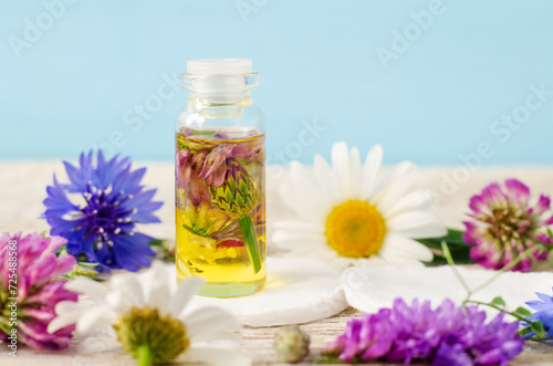 Small bottle with cosmetic oil. Aromatherapy, homemade beauty treatment and herbal medicine ingredients.