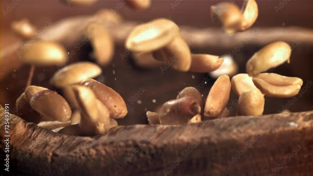 Peanuts fall into a wooden bowl. Filmed on a high-speed camera at 1000 fps. High quality FullHD footage Peanuts fall into a wooden bowl. Filmed on a high-speed camera at 1000 fps. High quality FullHD footage