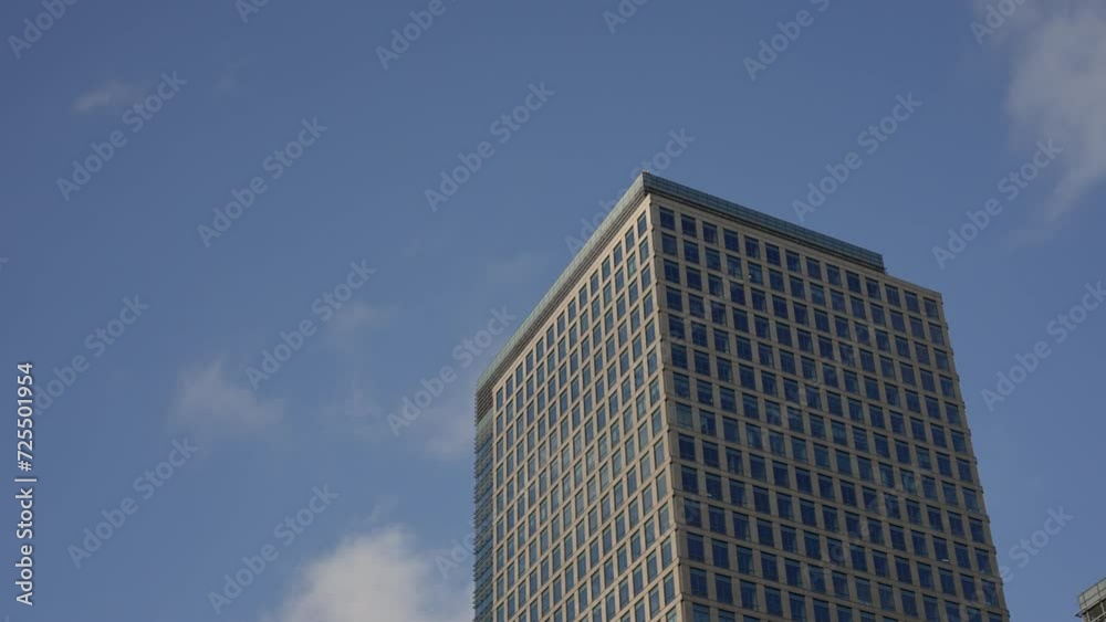 an old building stands proudly against a canvas of clear sky and drifting clouds. The weathered facade tells tales of time, while the serene backdrop the architectural charm. High quality 4k footage an old building stands proudly against a canvas of clear sky and drifting clouds. The weathered facade tells tales of time, while the serene backdrop the architectural charm. High quality 4k footage