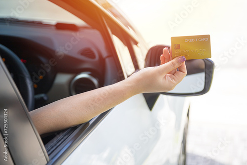 Closed up hand use credit card on car to pay for fuel