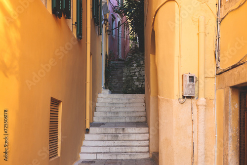 Fototapeta Naklejka Na Ścianę i Meble -  Corfu street view, Kerkyra old town beautiful cityscape, Ionian sea Islands, Greece, a summer sunny day, pedestrian streets with shops and cafes, architecture of historic center, travel to Greece