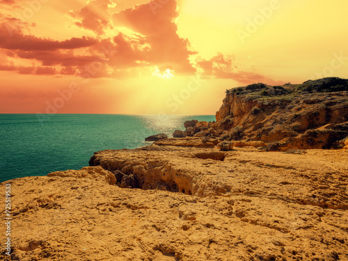 Rocky coast at sunset. Praia da Marinha beach in the Algarve region in the Atlantic Ocean, Portugal, Europe