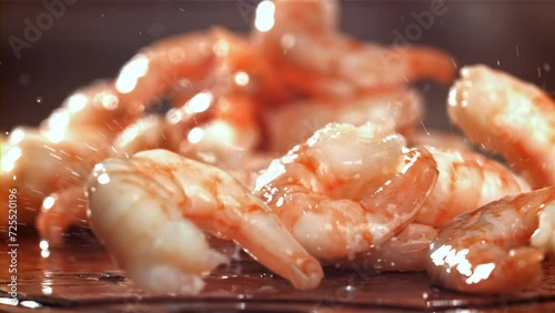 The shrimp falls on a wooden cutting board. Filmed on a high-speed camera at 1000 fps. High quality FullHD footage