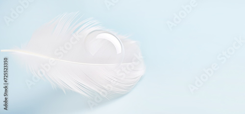 white light feather drop of water blue background