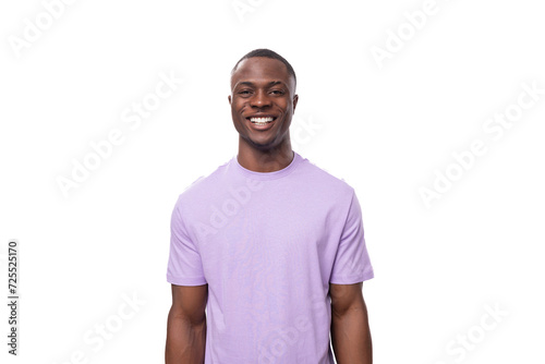 young positive american man in lilac t-shirt smiling on white background
